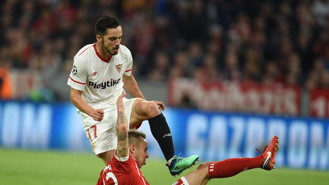 Bayerns Rafinha (unten) grätscht Sevillas Pablo Sarabia Garcia den Ball vom Fuß.