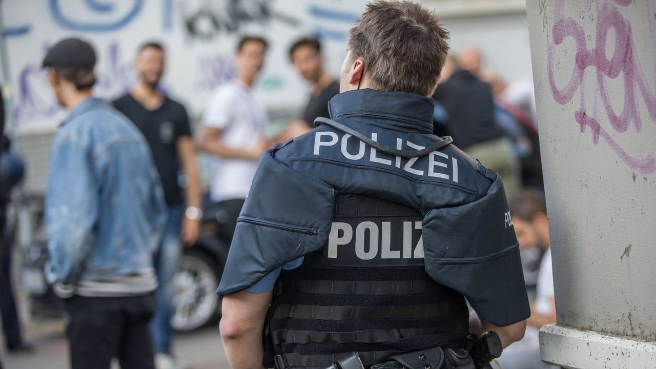 Polizisten bewachen eine Gruppe festgesetzter junger Männer neben dem Herrngarten am Rande der Darmstädter Innenstadt. Polizisten bewachen eine Gruppe festgesetzter junger Männer neben dem Herrngarten am Rande der Darmstädter Innenstadt.