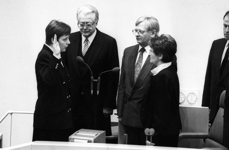 Bei der ersten gesamtdeutschen Wahl am Dezember 1990 gewann Merkel ihren Wahlkreis mit 48,5 Prozent. Kaum im Bundestag war sie auch schon Ministerin, hier bei der Vereidigung durch Bundestagspräsidentin Rita Süßmuth.