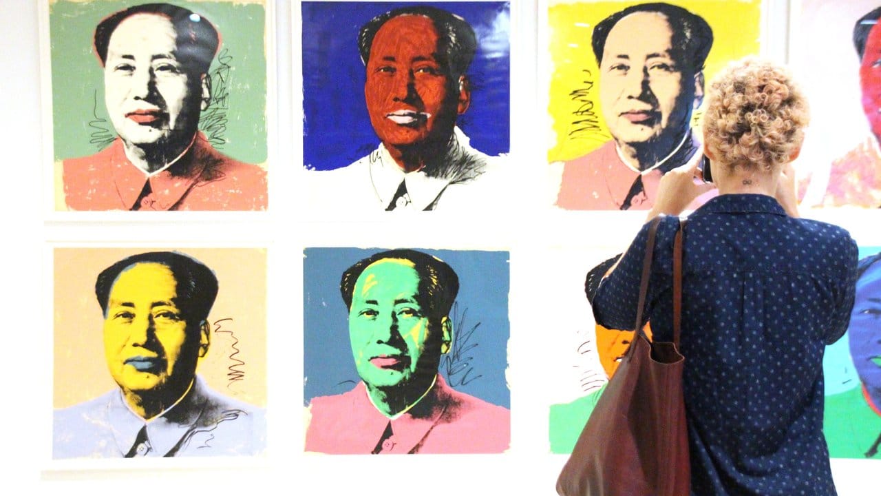Eine Besucherin fotografiert im New Yorker Whitney Museum Andy Warhols Bilderserie von Mao Zedong.