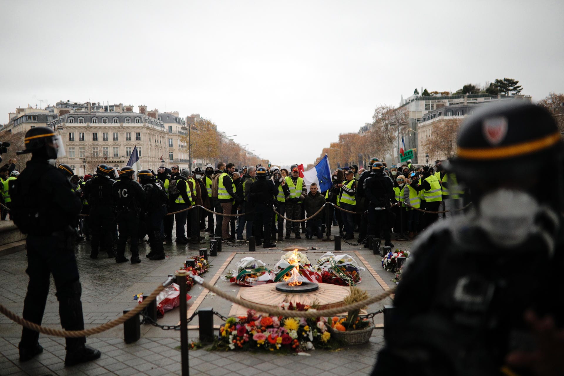 Sicherheitskräfte beaufsichtigen die Demonstranten am Triumphbogen in Paris: Hier ist die Stimmung noch friedlich...
