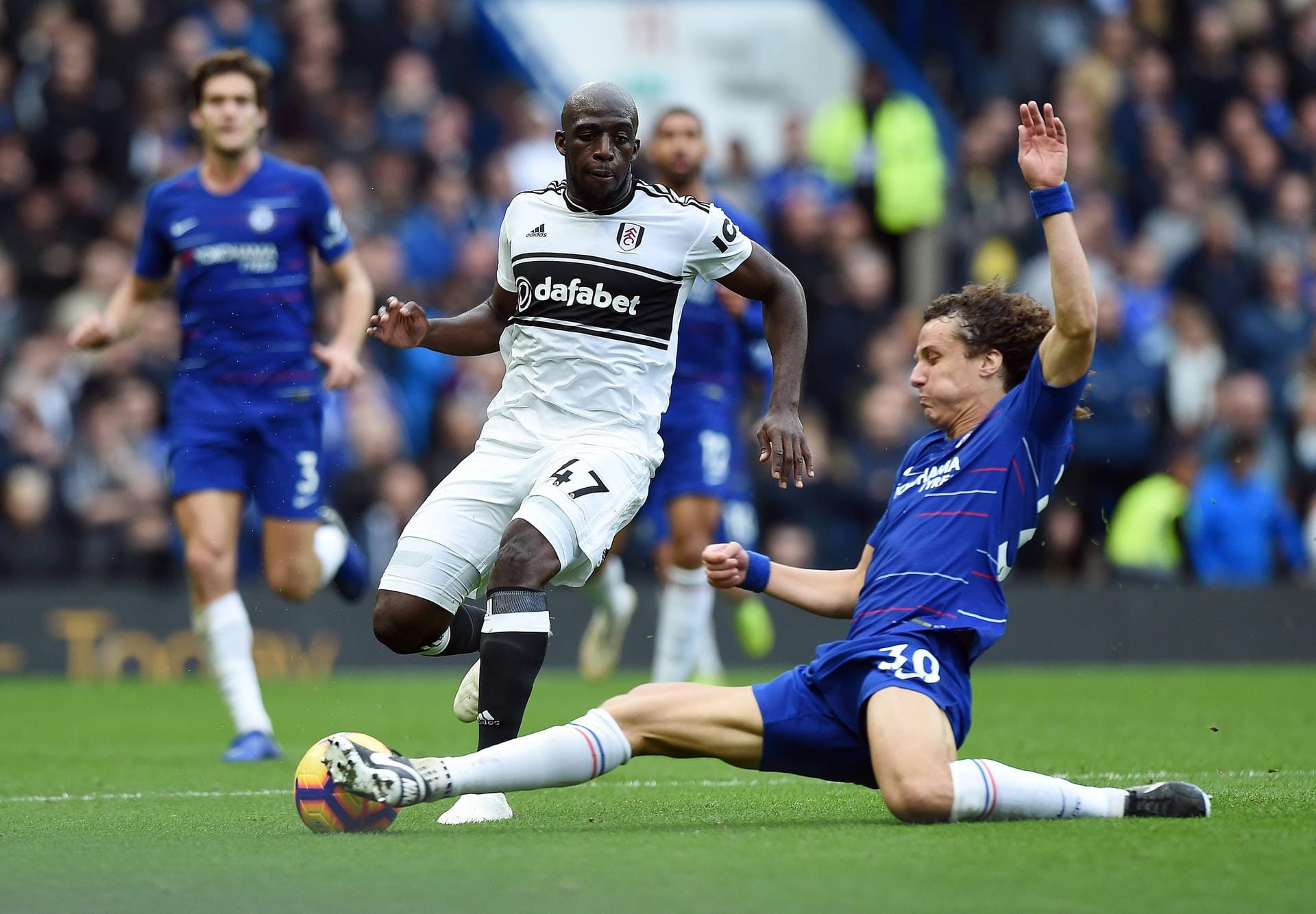 Aboubakar Kamara of Fulham is challenged by David Luiz of Chelsea during the Premier League match at
