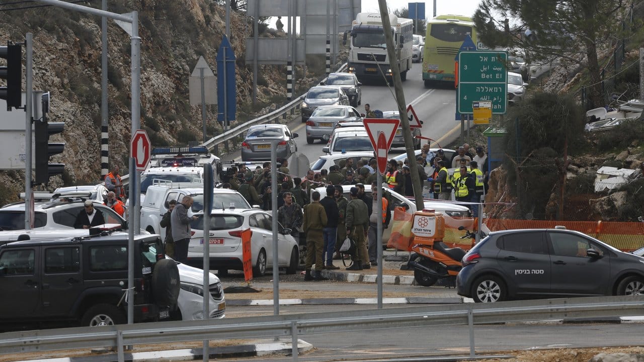 Israelische Soldaten und Mitarbeiter des Rettungsdienstes stehen am Ort des Anschlags.