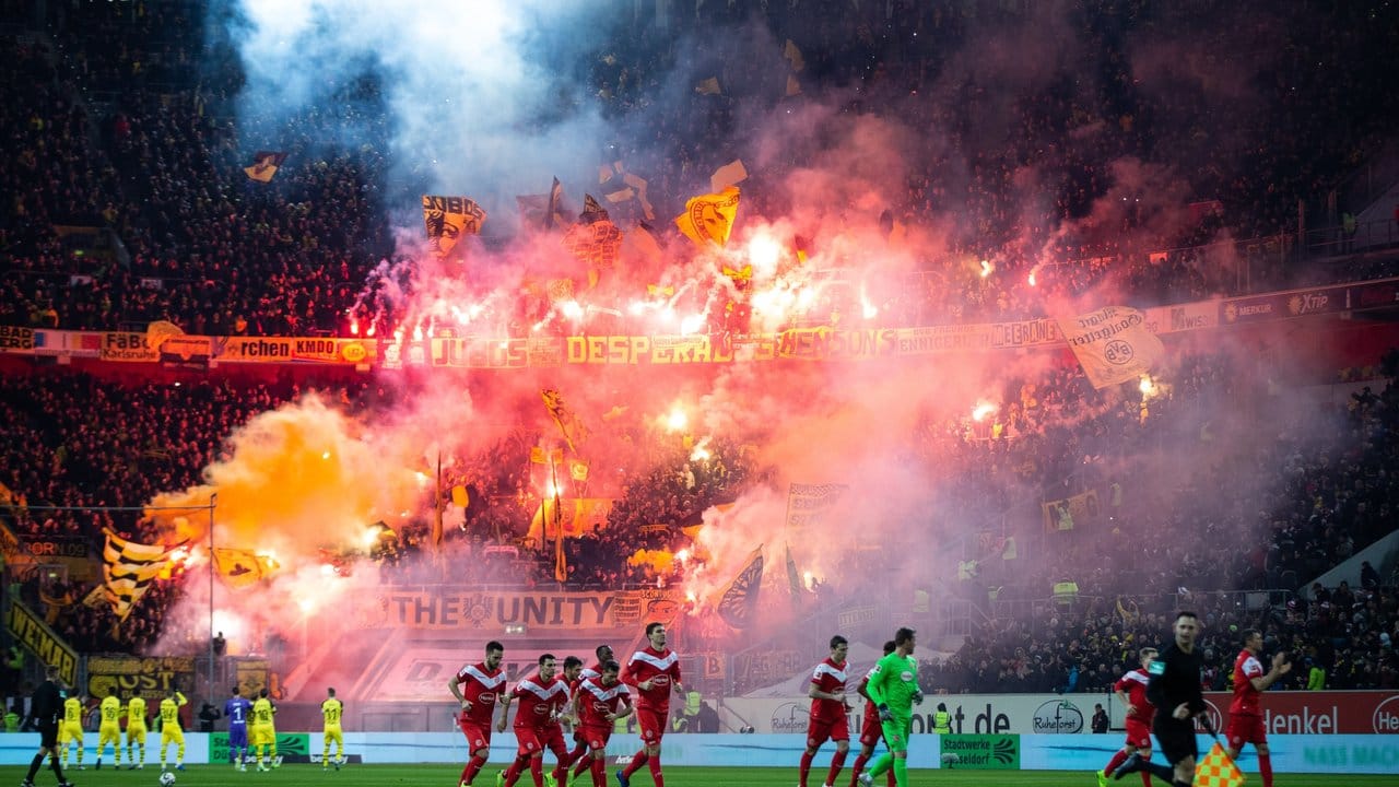 Dortmunds Fans verbrennen im Stadion von Fortuna Düsseldorf Pyrotechnik.