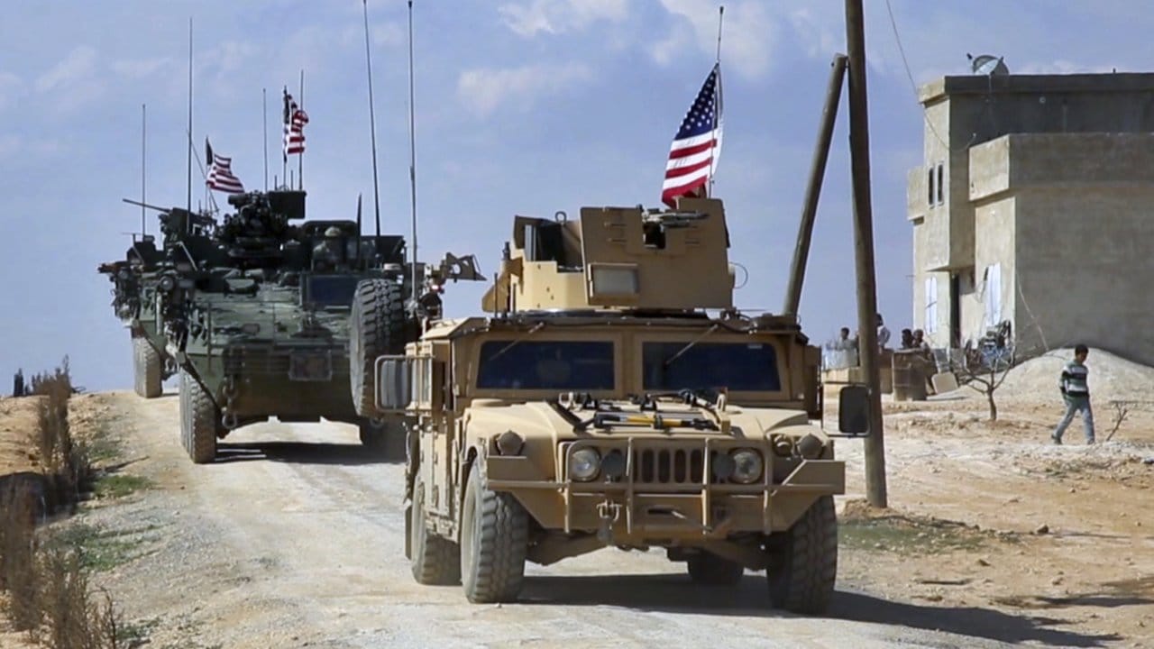 US-Truppen mit gepanzerten Fahrzeugen gehen in den Außenbezirken der Stadt Manbidsch in Stellung.