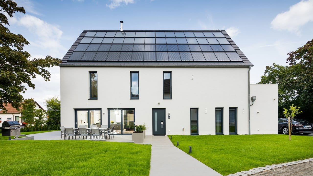 Große Photovoltaik- und Solarthermieanlagen auf diesem Plusenergiehaus erzeugen viel Energie für Wärme, Strom und Elektromobilität - mehr als der Haushalt selbst verbrauchen könnte.