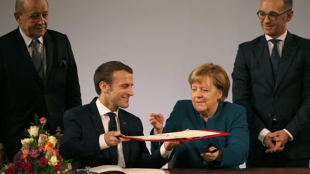 Emmanuel Macron und Bundeskanzlerin Angela Merkel werden flankiert von den Außenministern Jean-Yves Le Drian (l) und Heiko Maas.