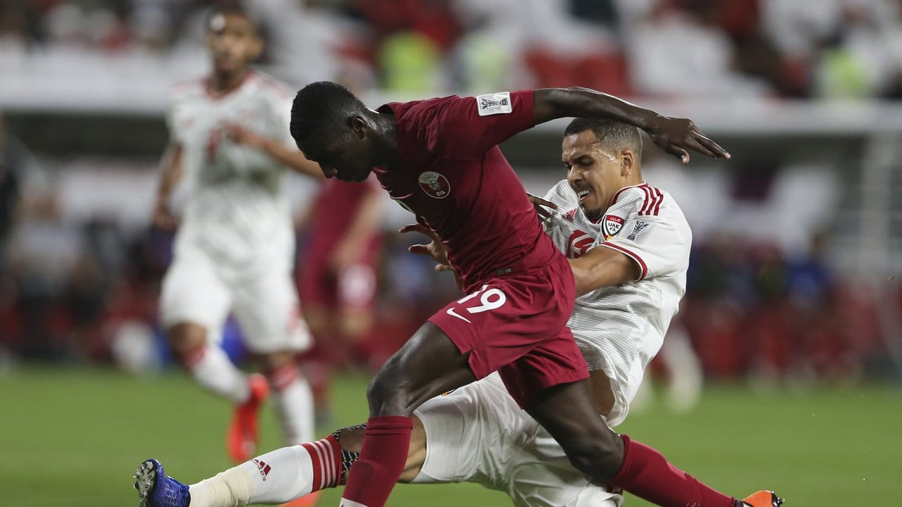 Der Katarer Almoez Ali (vorn) kämpft mit Ismail Ahmed von den Vereinigten Arabischen Emiraten um den Ball.