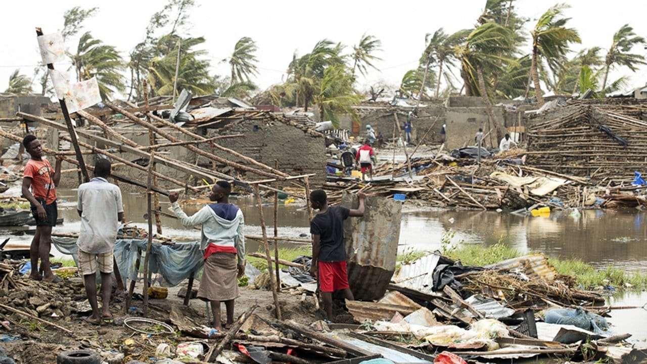 Menschen im Ort Beira in den Trümmern ihrer vom Sturm zerstörten Häuser.
