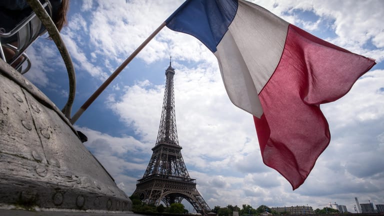 Die Flagge Frankreichs vor dem Eiffelturm: Der Turm wurde für die Pariser Weltausstellung gebaut und am 31. März 1889 fertiggestellt.