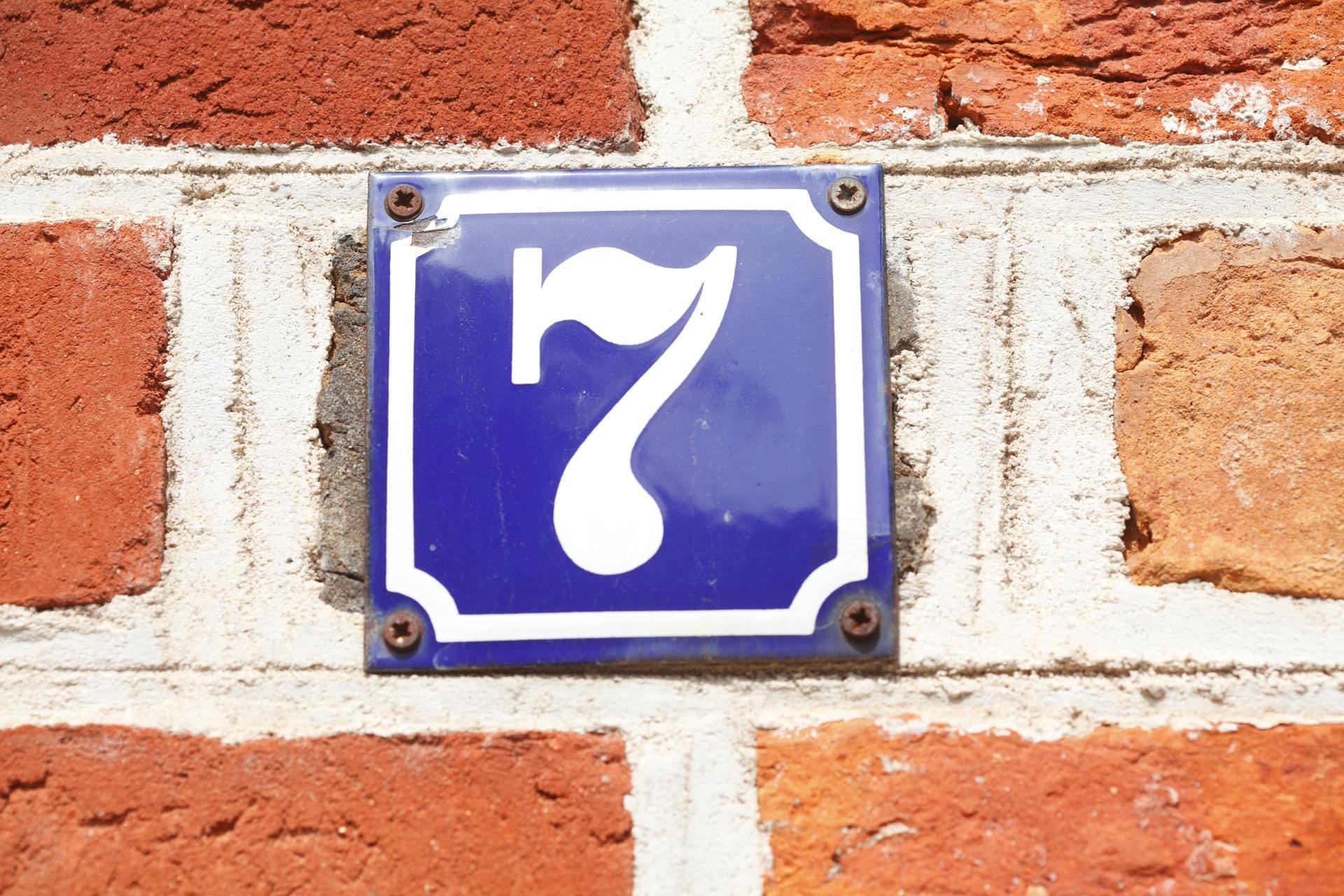 Ein standardisiertes Hausnummerschild an einer Backsteinmauer in Lüneburg.