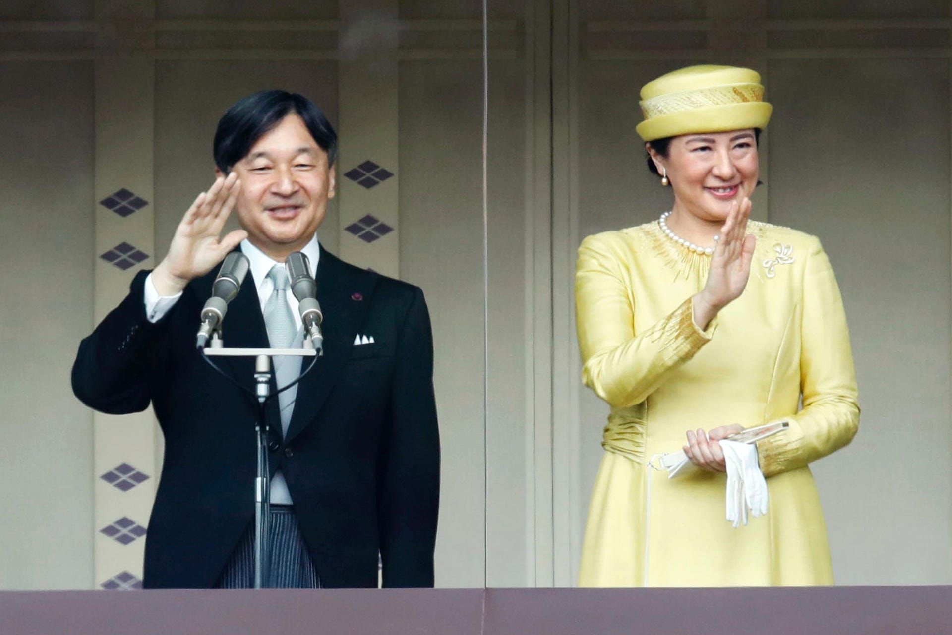 Naruhito und Masako winken den Gratulanten zu.