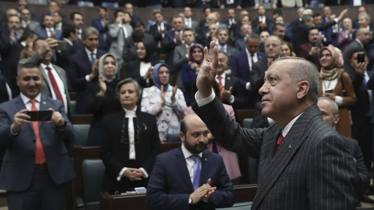 Recep Tayyip Erdogan winkt Anhängern im Parlament.