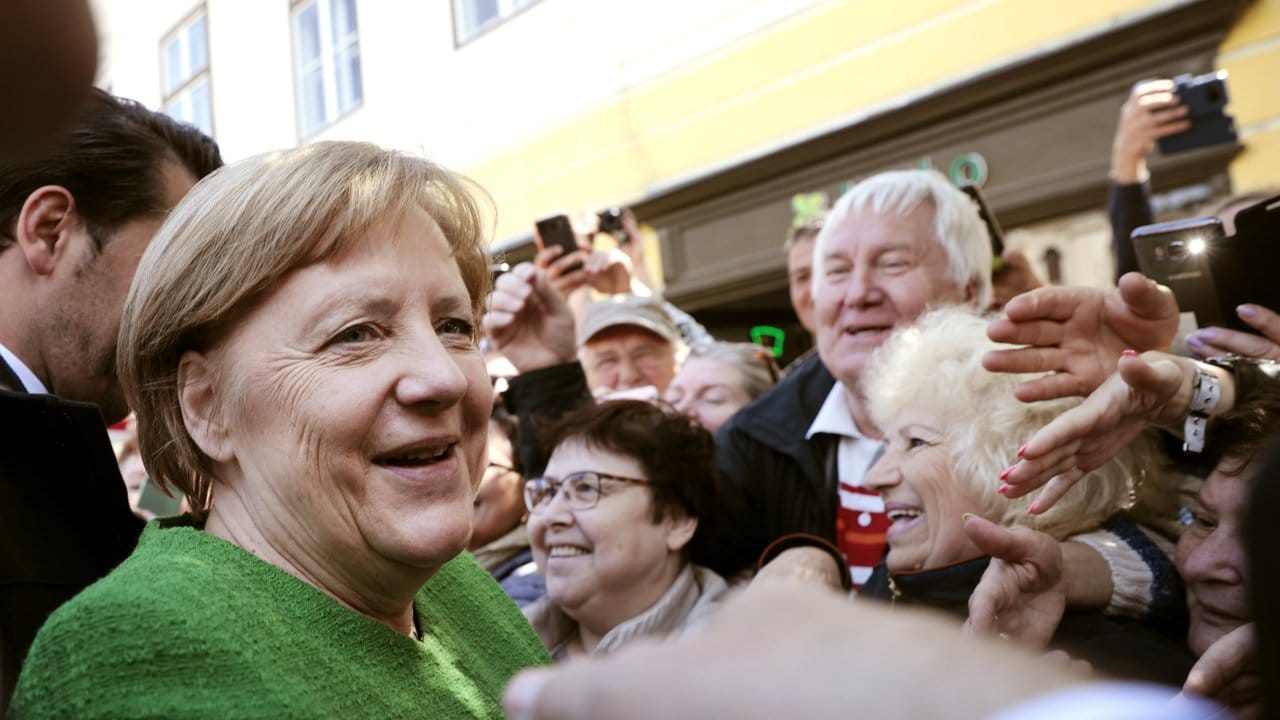 Von vielen Menschen wird Kanzlerin Angela Merkel während eines Spaziergangs in der siebenbürgischen Stadt Sibiu freudig begrüßt und fotografiert.