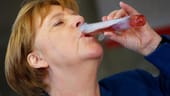 Angela Merkel mit Cocktail aus Reagenzglas