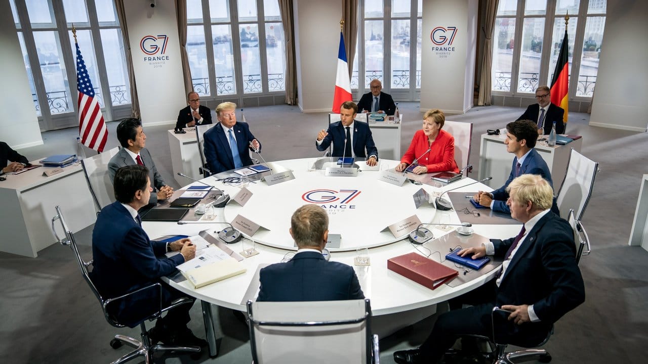 Die G7-Vertreter tagen in Biarritz: Emanuel Macron (Frankreich, M hinten), daneben im Uhrzeigersinn Bundeskanzlerin Angela Merkel, Justin Trudeau (Kanada), Boris Johnson (Großbritannien), EU-Ratspräsident Donald Tusk, Giuseppe Conte (Italien), Shinzo Abe (Japan) und Donald Trump (USA).