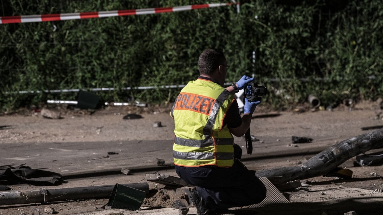 Ein Polizeibeamter fotografiert nach dem schweren Verkehrsunfall in Berlin-Mitte Spuren.