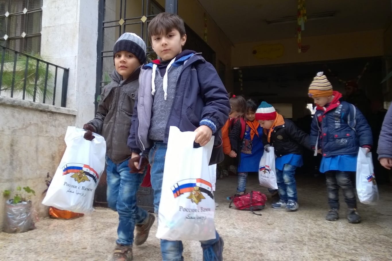 Russian soldiers bring presents to schoolchildren in Aleppo, Syri