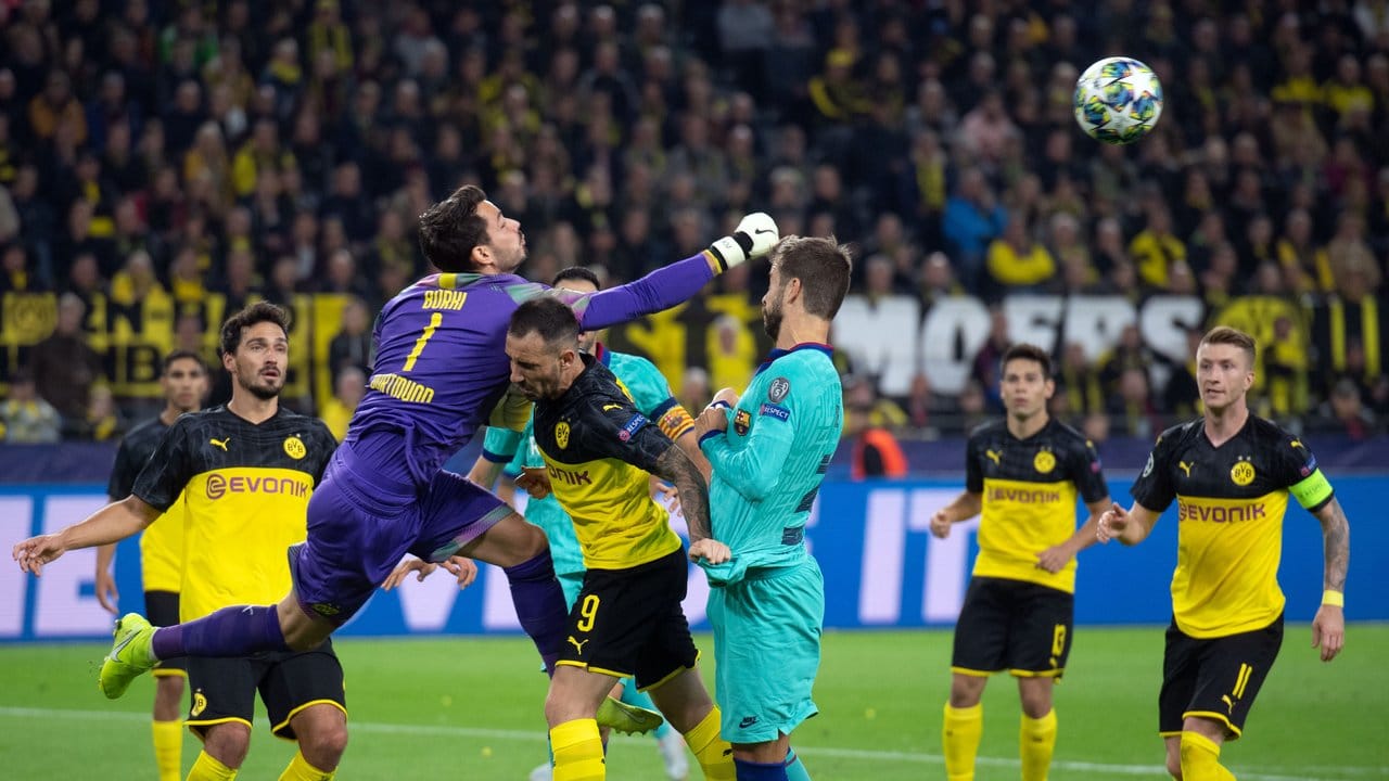 Dortmunds Torwart Roman Bürki faustet neben Paco Alcacer den Ball fort.