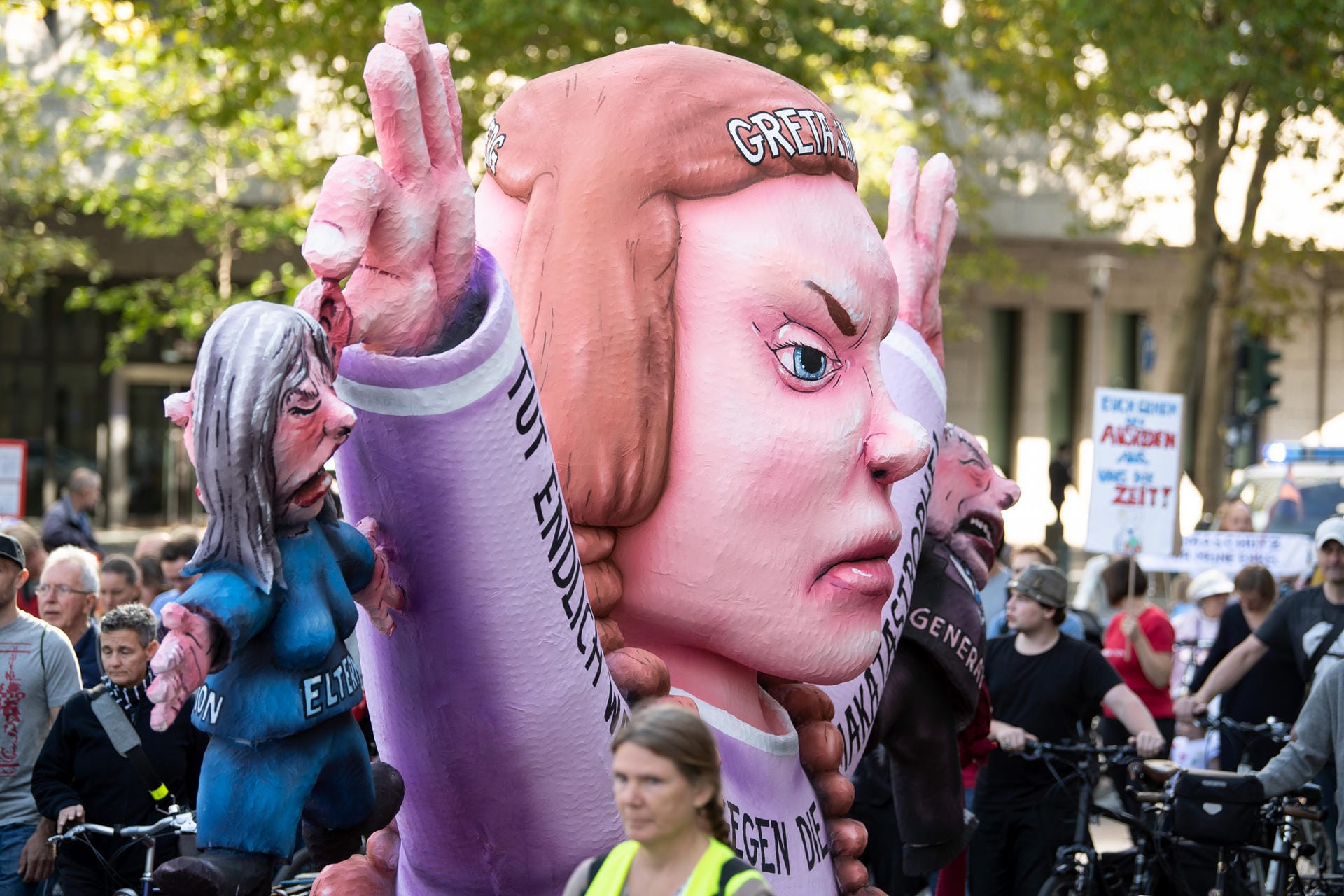 Eine überlebensgroße Figur von Greta Thunberg wird bei der Demonstration in Düsseldorf auf einem Anhänger durch die Stadt gefahren.