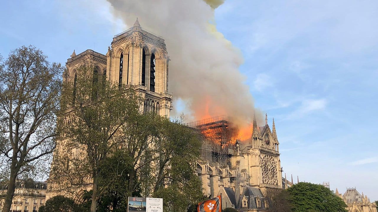 Flammen und Rauch steigen von einem der berühmtesten Wahrzeichen der Welt, der Pariser Kathedrale Notre-Dame, auf.