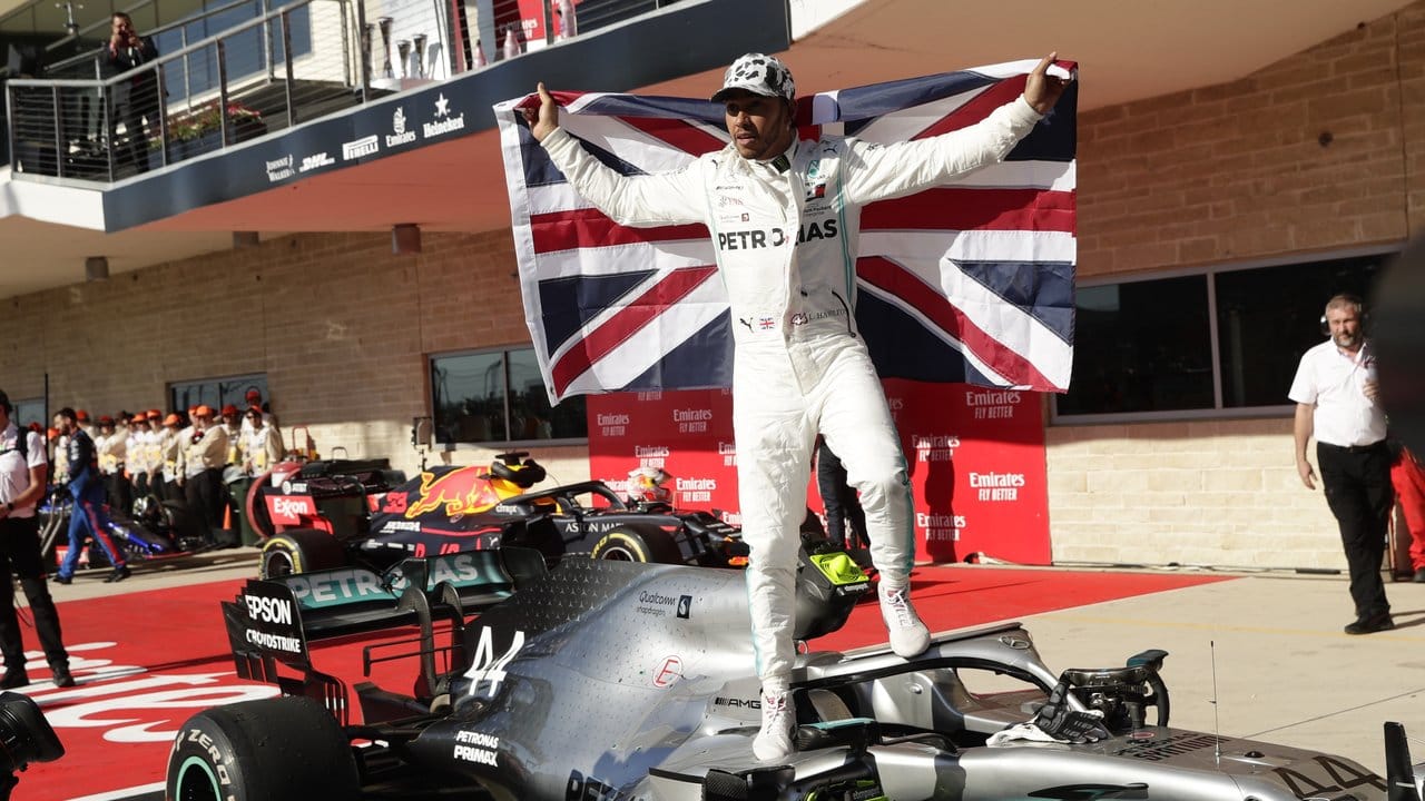 Lewis Hamilton klettert mit der britischen Fahne auf seinen Silberpfeil und feiert den sechsten Weltmeistertitel.