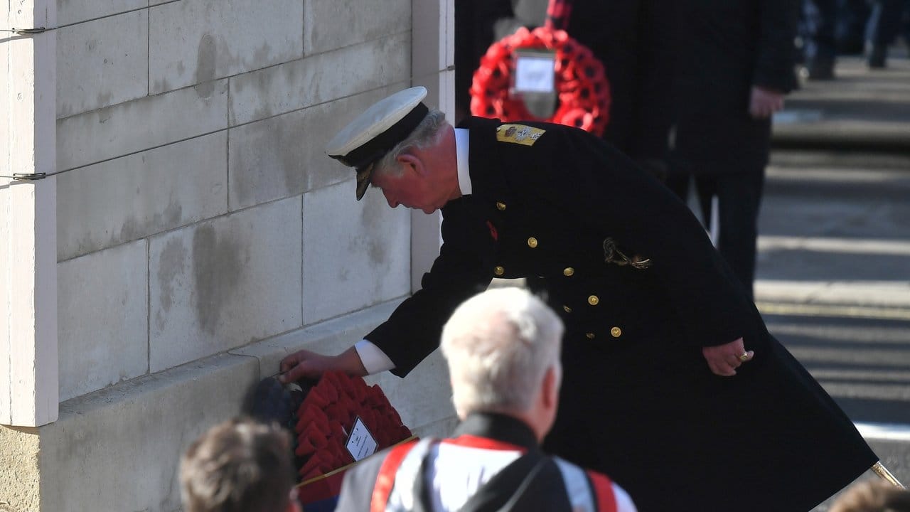 Prinz Charles legt einen Kranz aus roten Mohnblüten nieder.