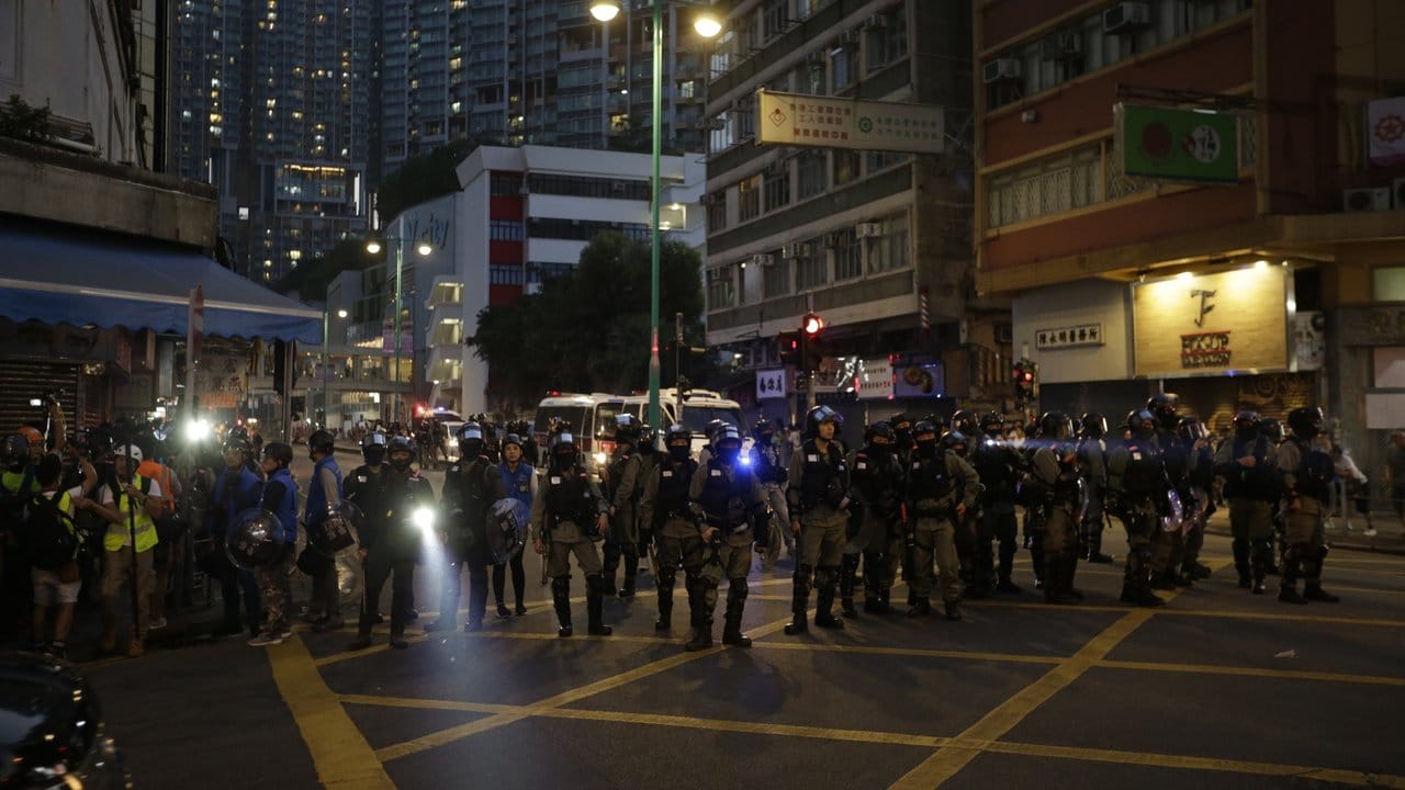 Polizisten blockieren eine Straße in Hongkong.