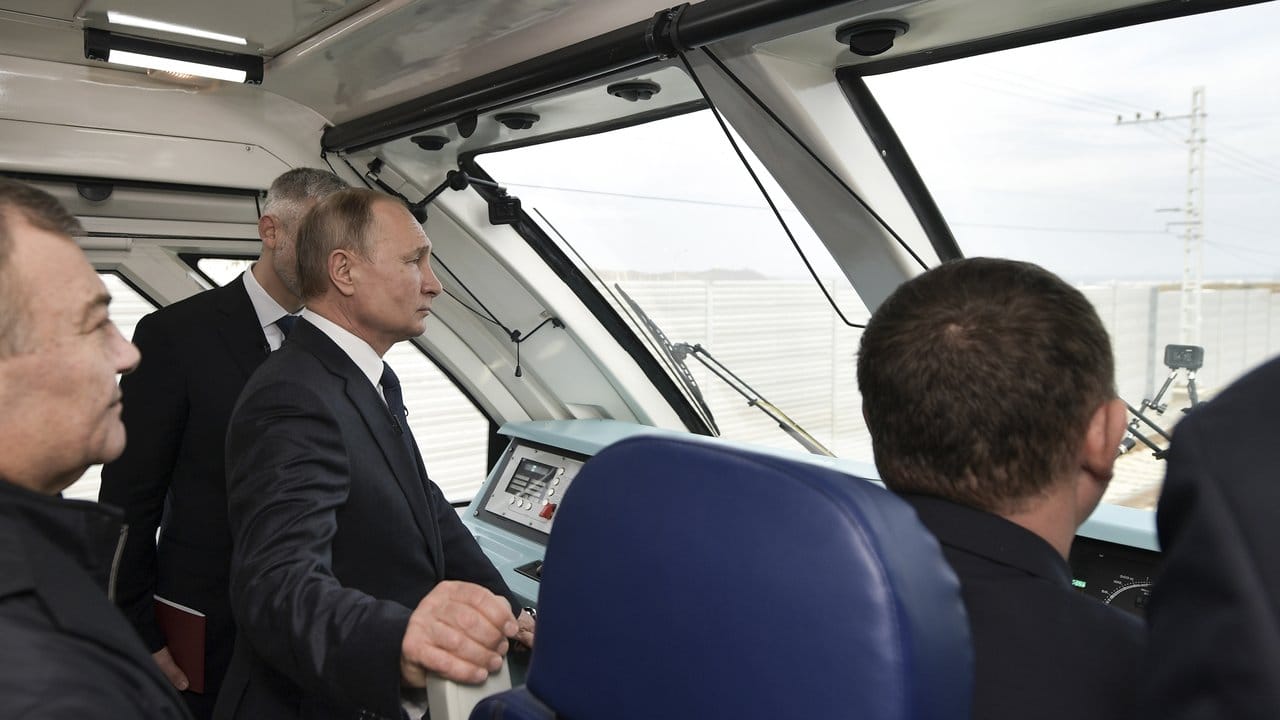 Im Führerstand: Wladimir Putin fährt per Zug über die neue 19 Kilometer lange Brücke, die die Krim mit dem russischen Festland verbindet.