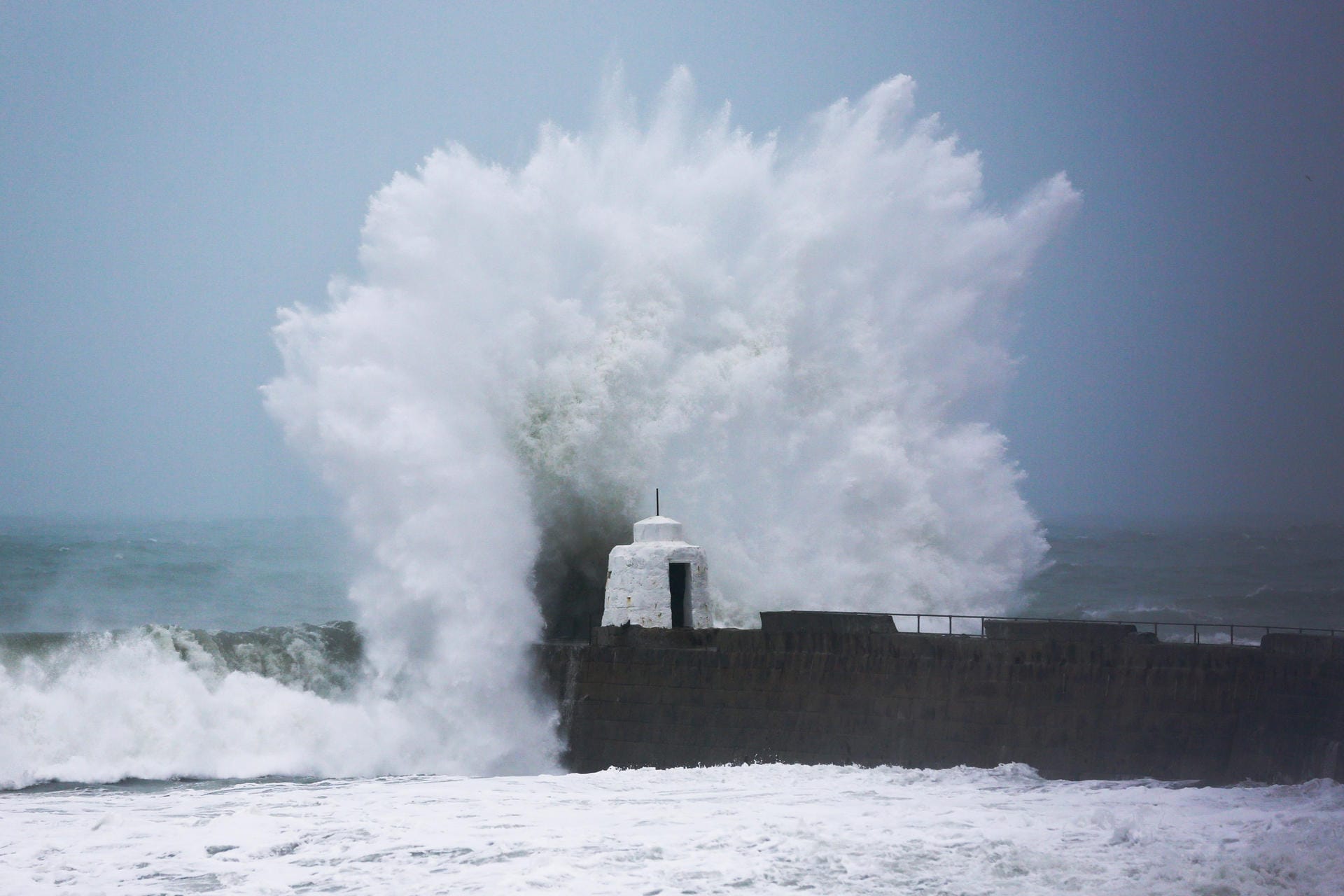 Die malerische Hafenmauer von Portreath in Cornwall: Die Wellen schlagen mit großer Kraft dagegen. Ganz Großbritannien leidet unter dem Sturm "Dennis", doch in Cornwall, Wales und Schottland ist die Lage besonders schlimm.