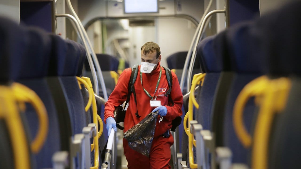 Eine Reinigungskraft säubert den Waggon eines Regionalzuges auf einem Bahnhof in Mailand.