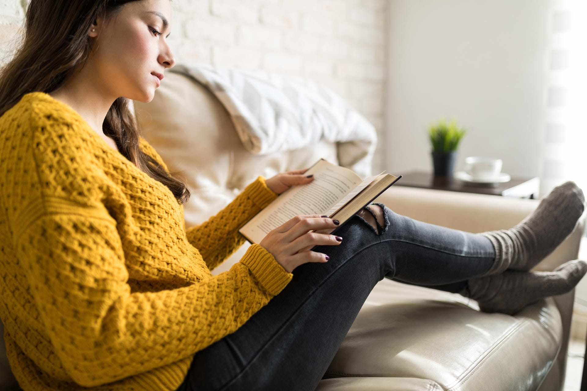 Lesen: Machen Sie es sich mit einem Buch auf der Couch oder dem Balkon gemütlich.
