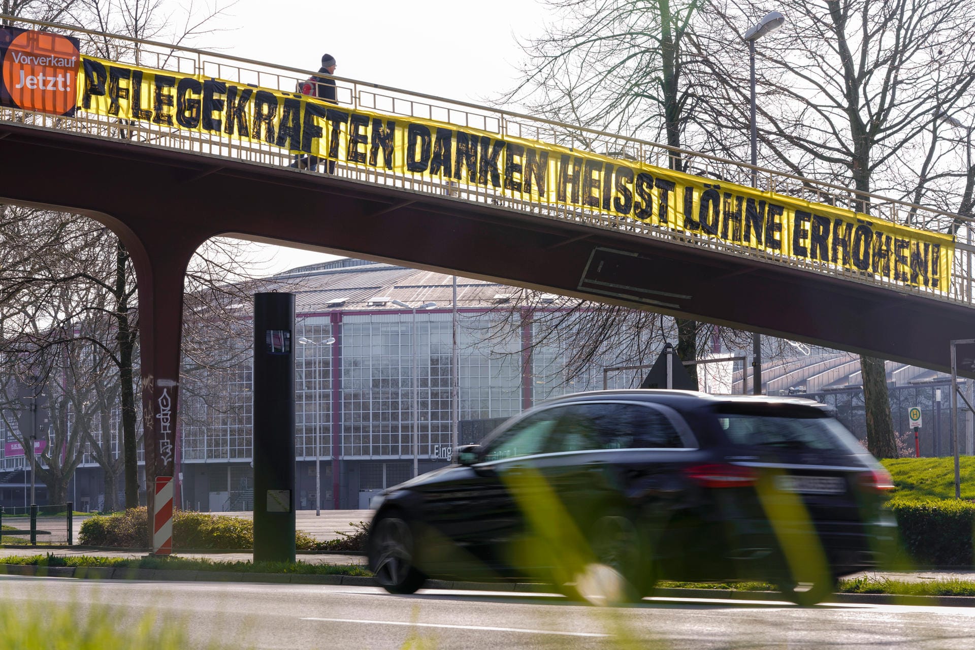 In Dortmund sind die Fans noch einen Schritt weitergegangen. An einer Brücke hängt ein Plakat, in dem höhere Löhne für die Pflegekräfte gefordert werden.