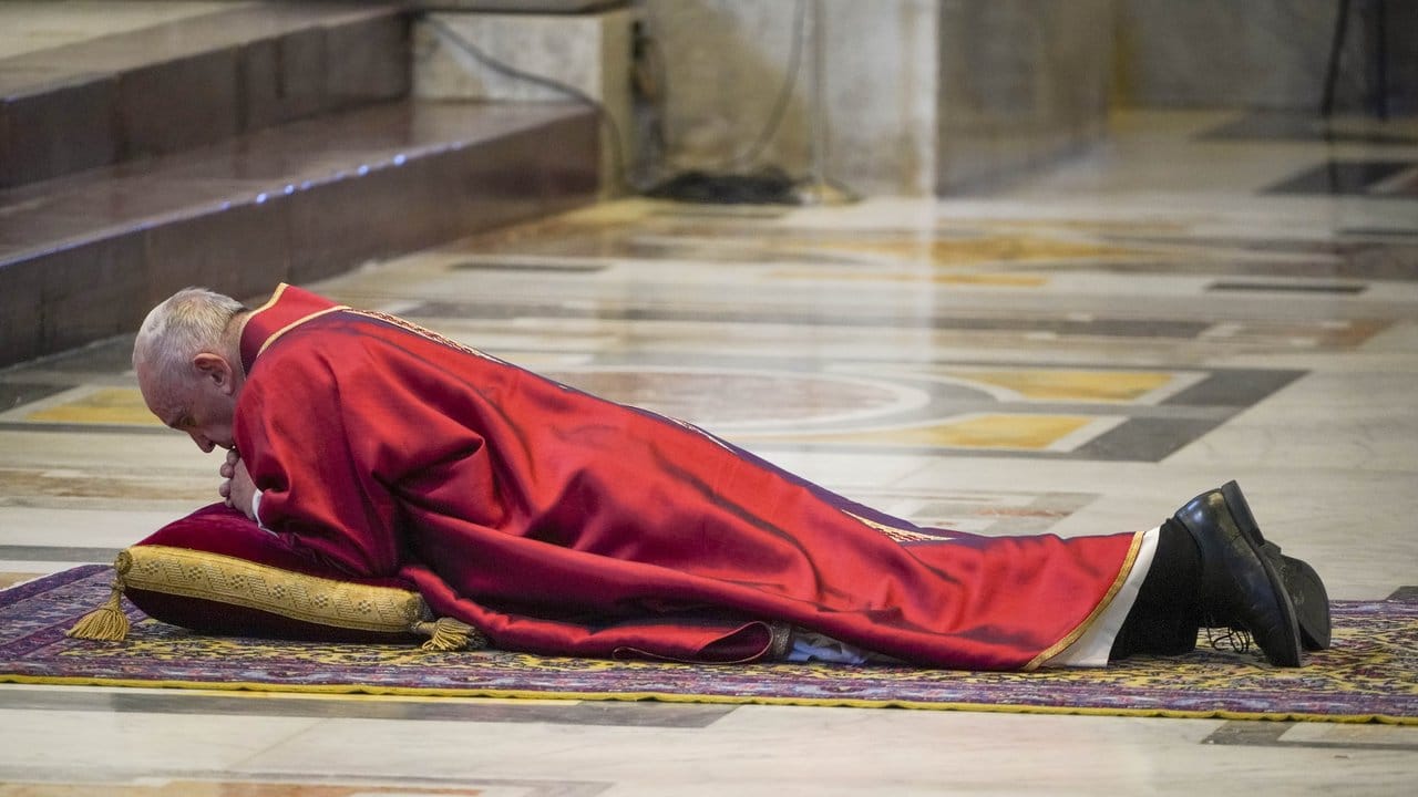 Papst Franziskus wirft sich im Rahmen der Feier vor der traditionellen Kreuzweg-Prozession im Altarraum des Petersdoms nieder. Papst Franziskus wirft sich im Rahmen der Feier vor der traditionellen Kreuzweg-Prozession im Altarraum des Petersdoms nieder.