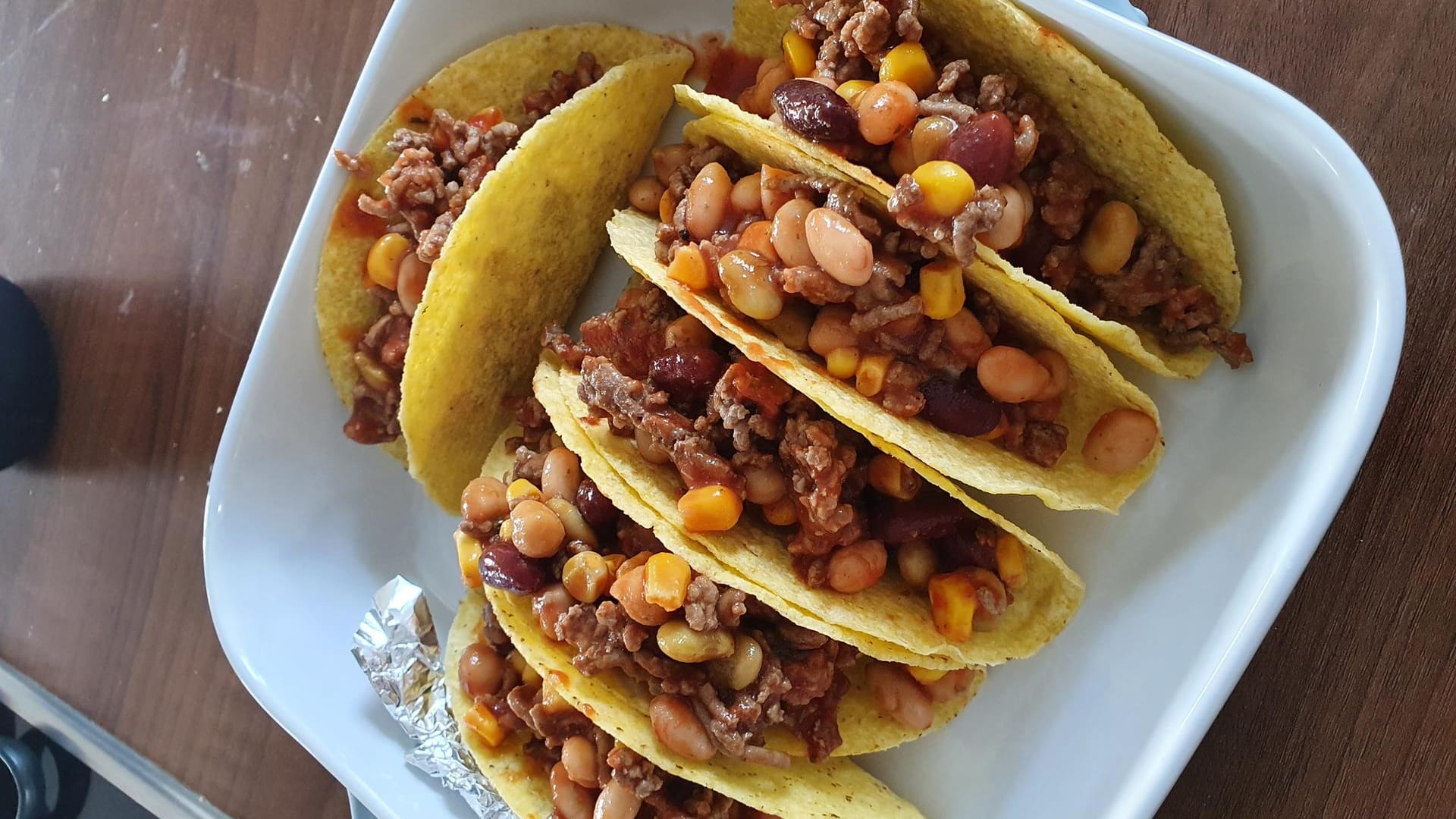 Verteilen Sie die zuvor vorbereitete Hackfleischfüllung auf die Taco Shells.