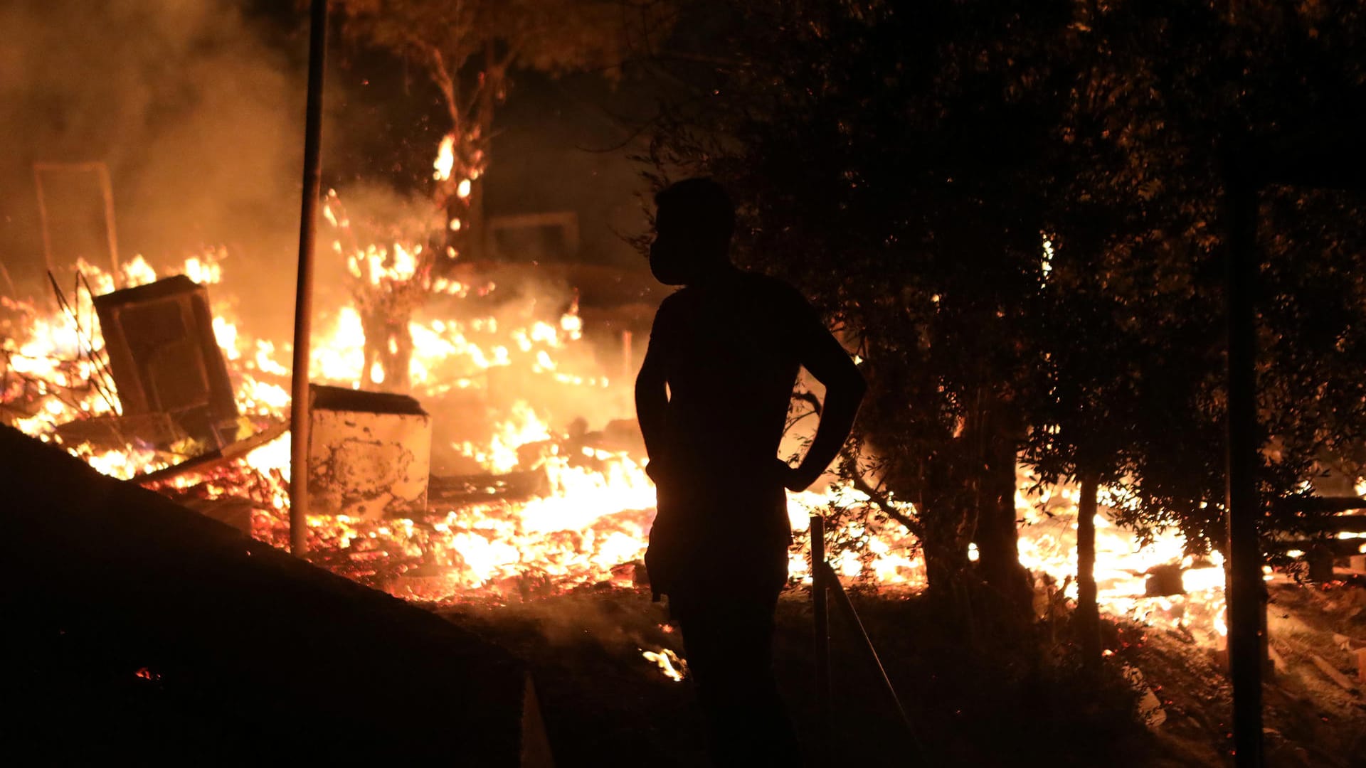Fire burns at the Moria camp for refugees and migrants on the island of Lesbos