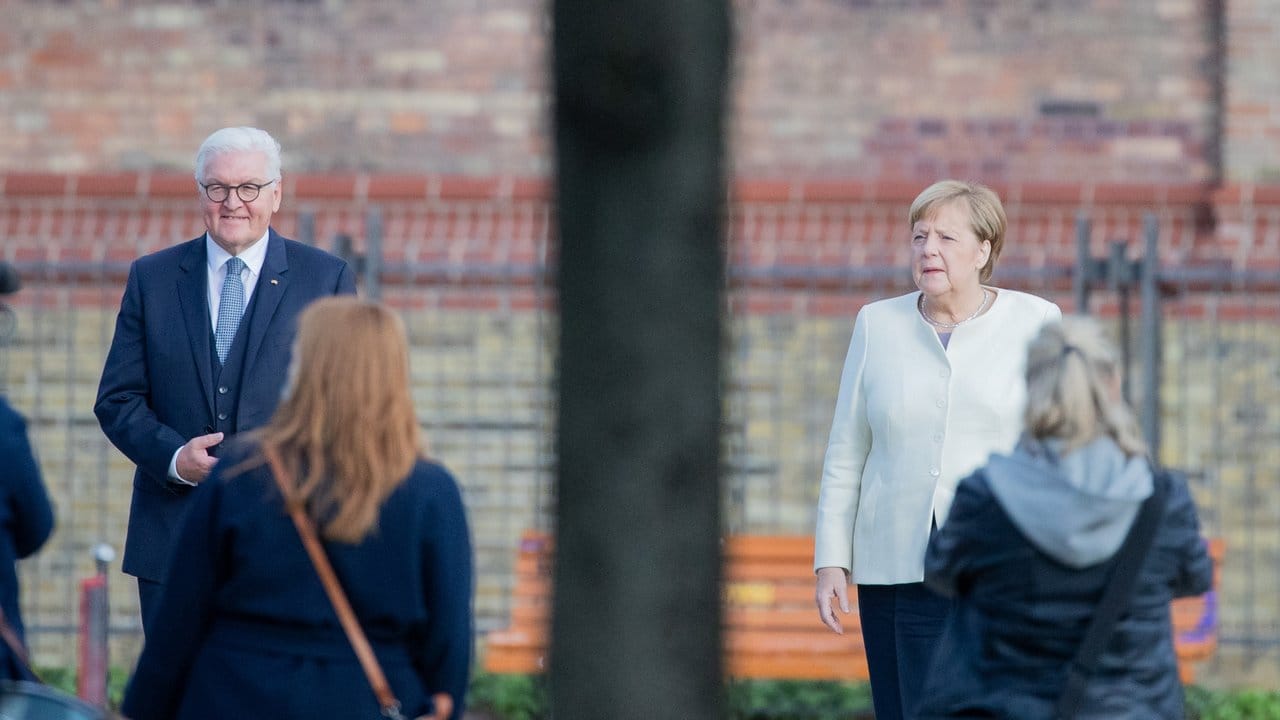 Bundespräsident Frank-Walter Steinmeier und Bundeskanzlerin Angela Merkel posieren für ein Foto vor der Kirche St.