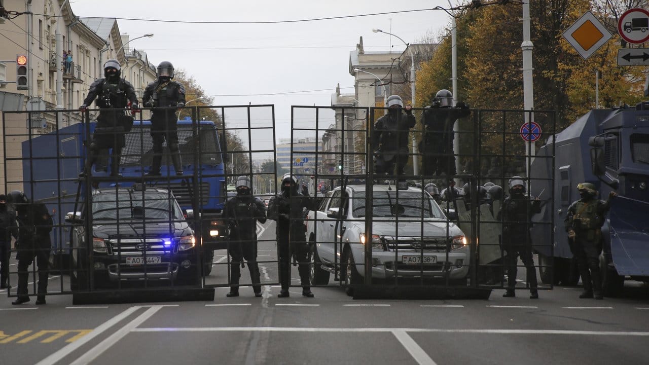 Belarussische Polizeibeamte blockieren während eines Protests eine Straße.