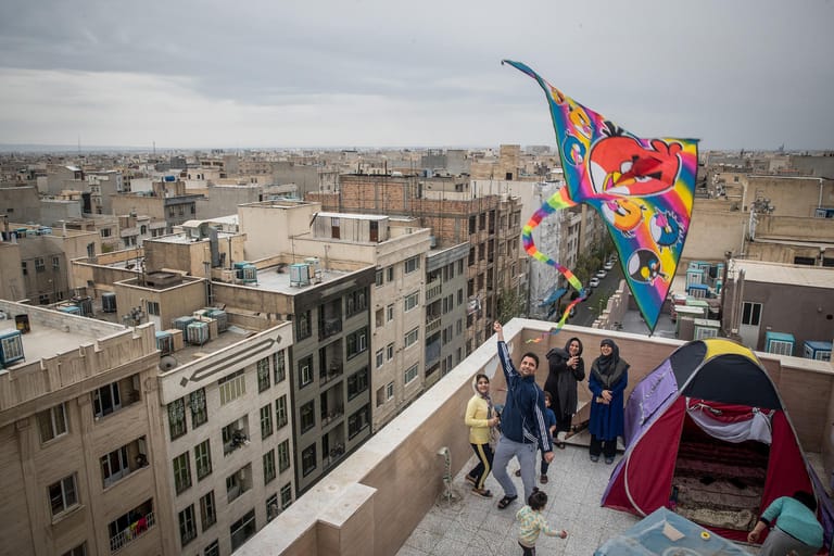 Eine ehrenvolle Erwähnung findet die Jury auch für den Fotografen Erfan Kouchari. In Teheran, der Hauptstadt des Irans, hält er die Glücksmomente von Kindern in der Corona-Pandemie fest. Im Lockdown fliehen die Kinder auf die Flachdächer der Stadt. Dort lassen sie Drachen steigen, bauen Zelte, skaten oder legen einen Garten an.
