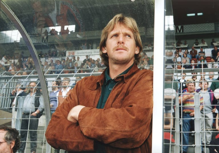 Coach Bernd Schuster an die Trainerbank gelehnt