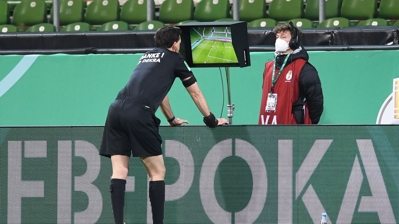 Schiedsrichter Manuel Gräfe nimmt den Videobeweis zu Hilfe und nimmt einen gegebenen Elfmeter zurück.