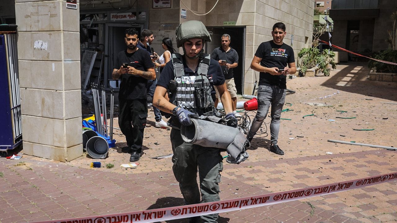 Ein Mitglied der israelischen Sicherheitskräfte hat die Überreste einer palästinensischen Rakete eingesammelt.
