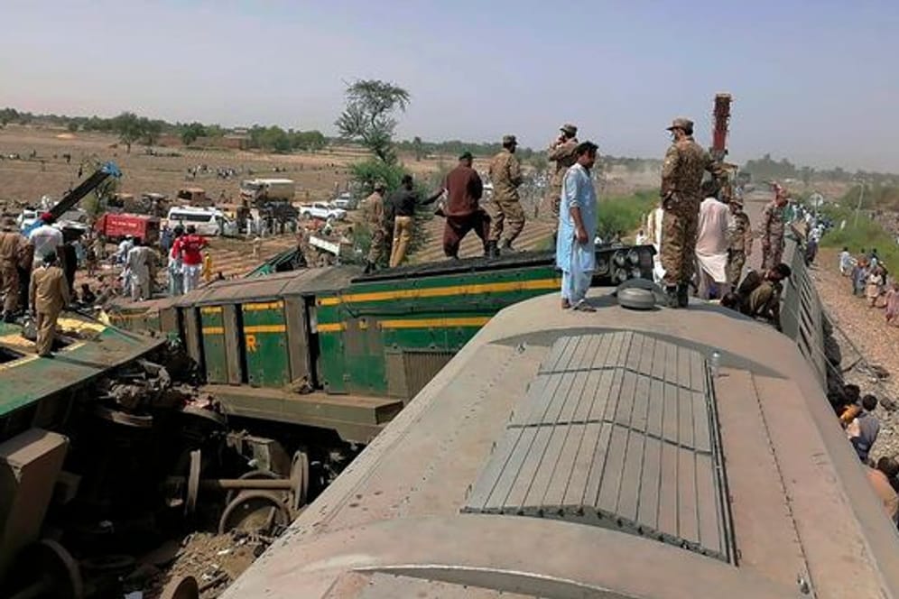 Truppen der pakistanischen Armee und Rettungskräfte am Ort der Zugkollision.