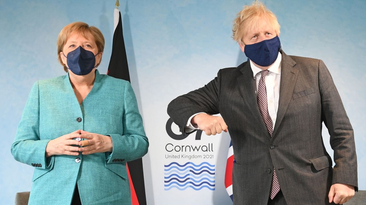 Der britische Premierminister Boris Johnson gestikuliert bei dem Fotoshooting mit Angela Merkel.