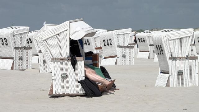 Touristen in einem Strandkorb am Strand von St.