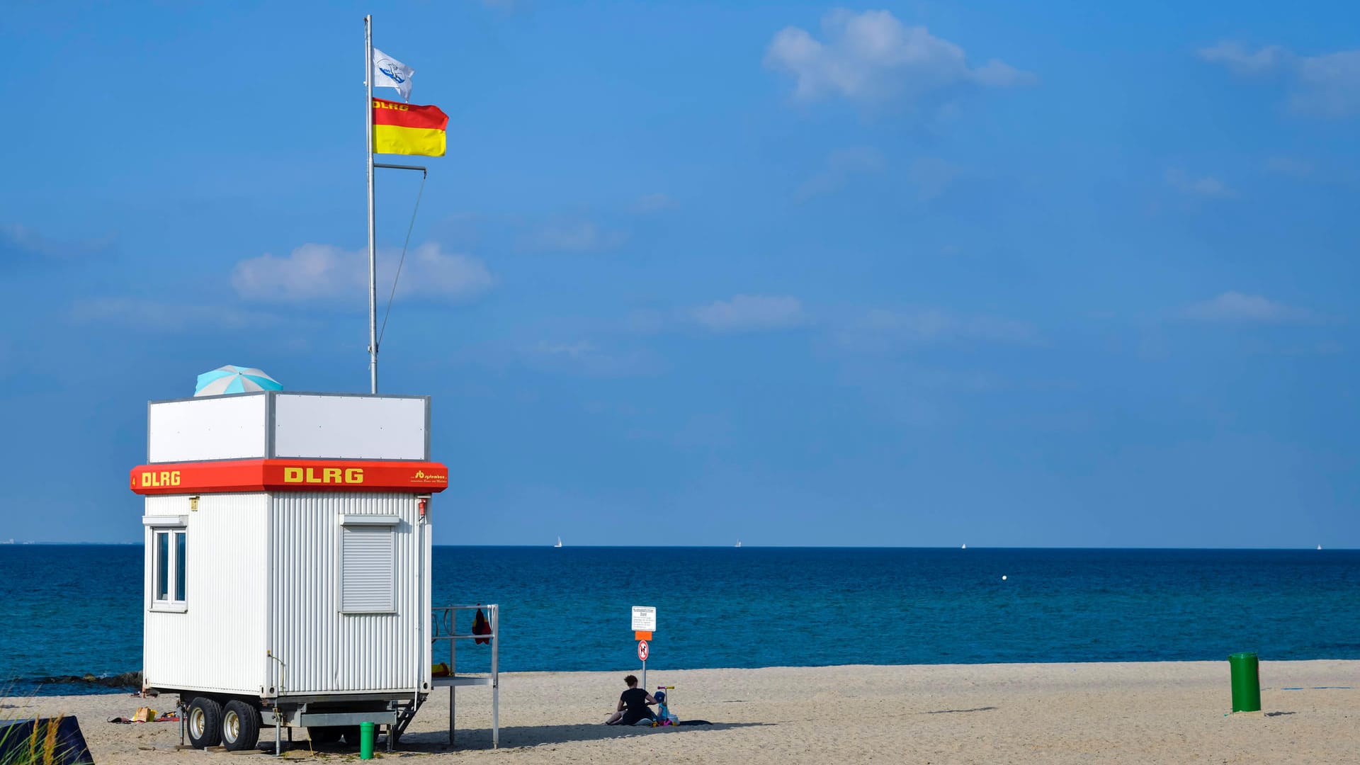 Rot-gelbe Flagge: Diese Flagge heißt: Hier ist eine ausgewiesene Badezone. Diese wird nach rechts und links von den rot-gelben Flaggen begrenzt. Die DLRG-Flagge darüber signalisiert, dass ein Rettungsschwimmer im Einsatz ist.