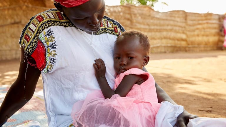 Adut drückt sich schüchtern an ihre Mutter. Das Mädchen aus dem Südsudan ist akut mangelernährt.