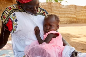 Adut drückt sich schüchtern an ihre Mutter. Das Mädchen aus dem Südsudan ist akut mangelernährt.