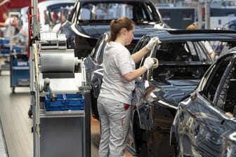 Eine Mitarbeiterin montiert Ausstattung in einer Automontagelinie (Symbolbild): Die deutsche Industrie beklagt einen Auftragseinbruch.