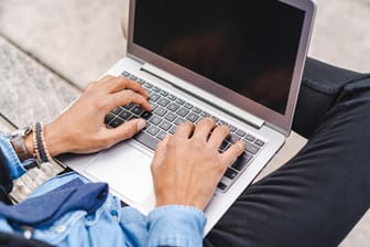 Ein Mann tippt etwas in seinen Laptop: Wegen einer Betrugsmasche im Internet hat ein Mann aus Erfurt knapp 10.000 Euro verloren.